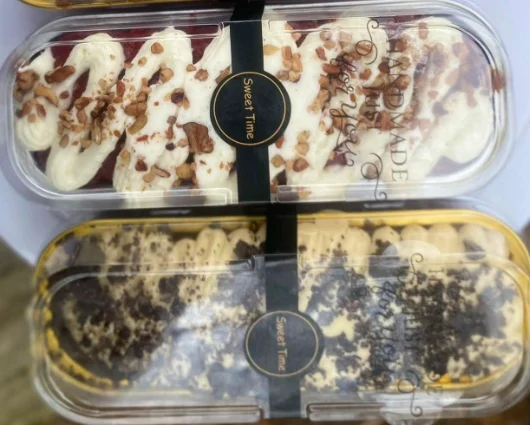 Two mini cakes in long clear boxes